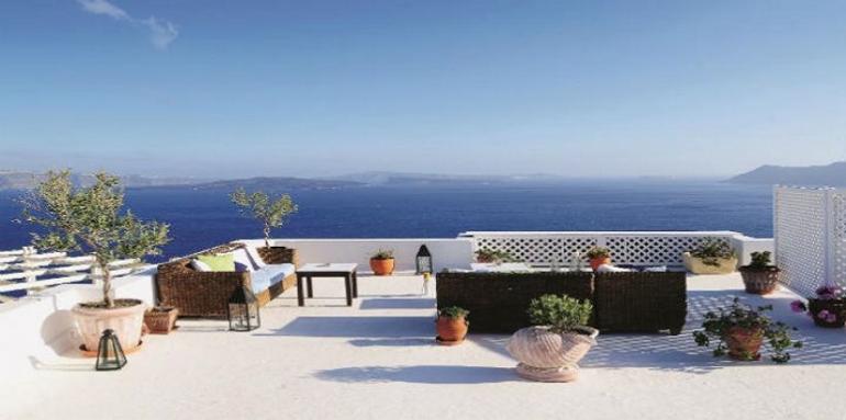 Terraza frente al mar con plantas y muebles