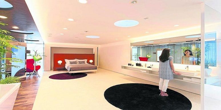 Dormitorio con un espejo que la persona le permite realizar simulaciones de maquillaje y de combinación de atuendos 