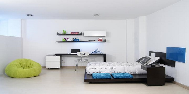 Habitación con cama doble, escritorio y puff
