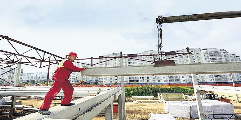 Obrero sosteniendo bloque de cemento en construcción